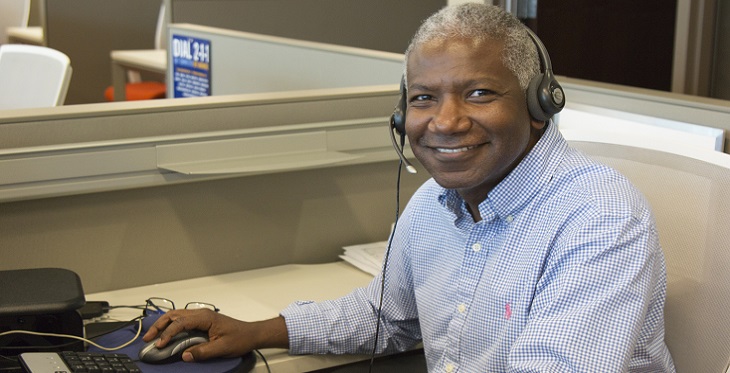 Person at a desk with headset on.